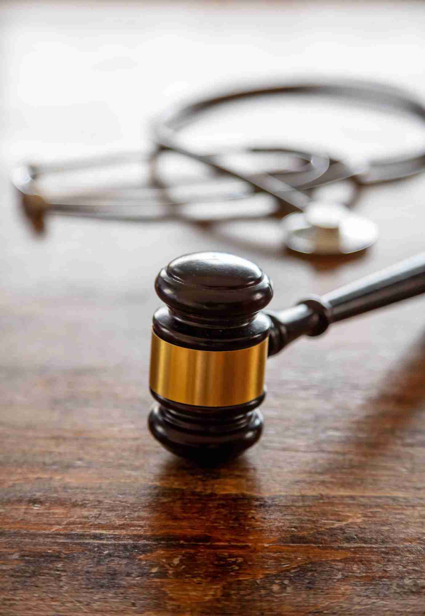 Healthcare Law. Medical stethoscope and judge gavel on lawyer office desk